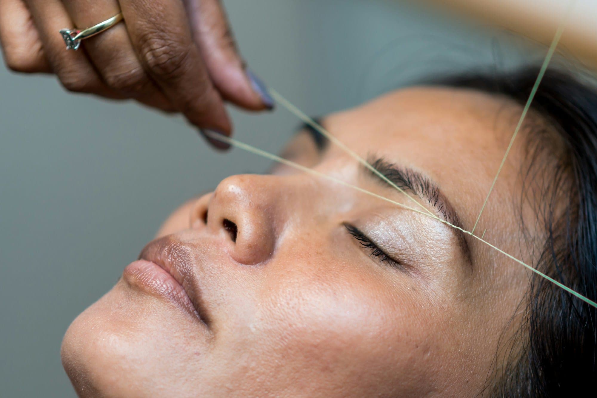 Eyebrow shaping during a threading appointment