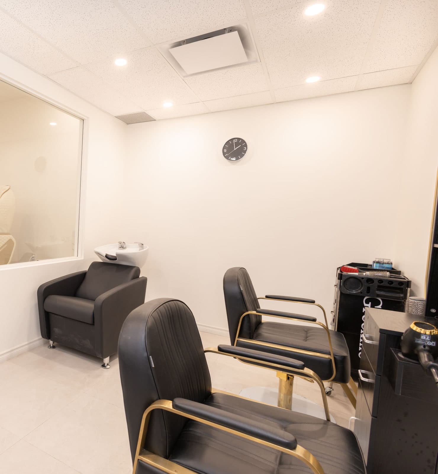 The hair room at CHIC with styling chairs and a shampoo station