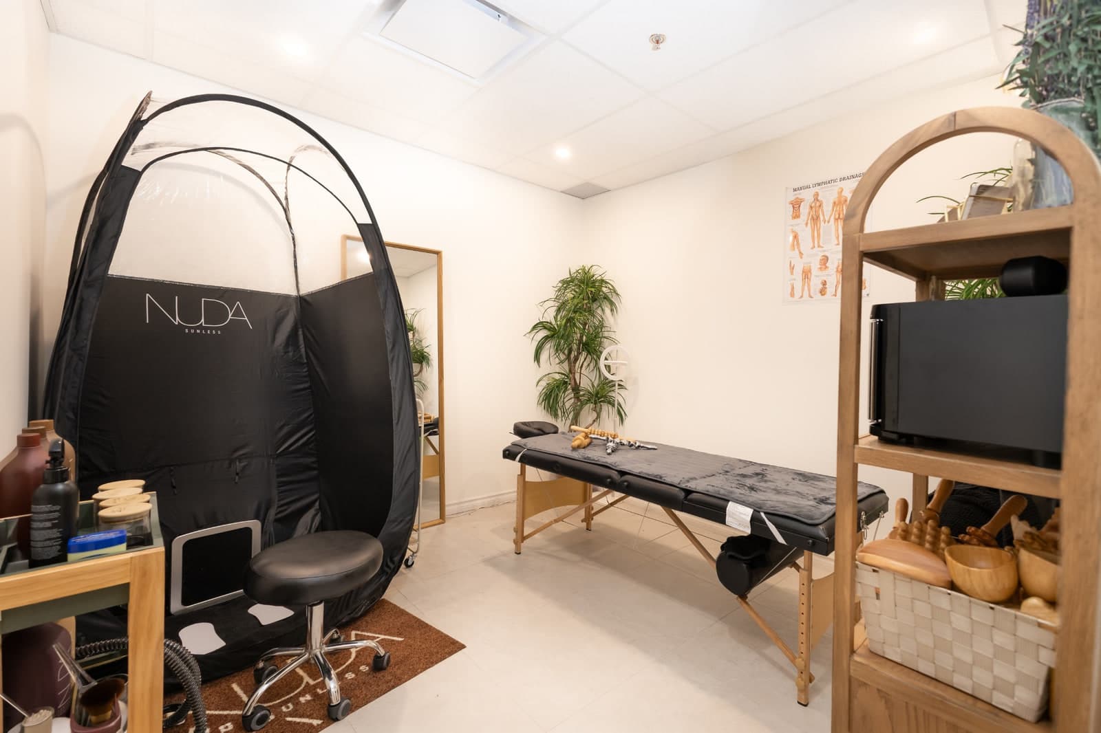 A private treatment room at CHIC with a massage table and wooden tools